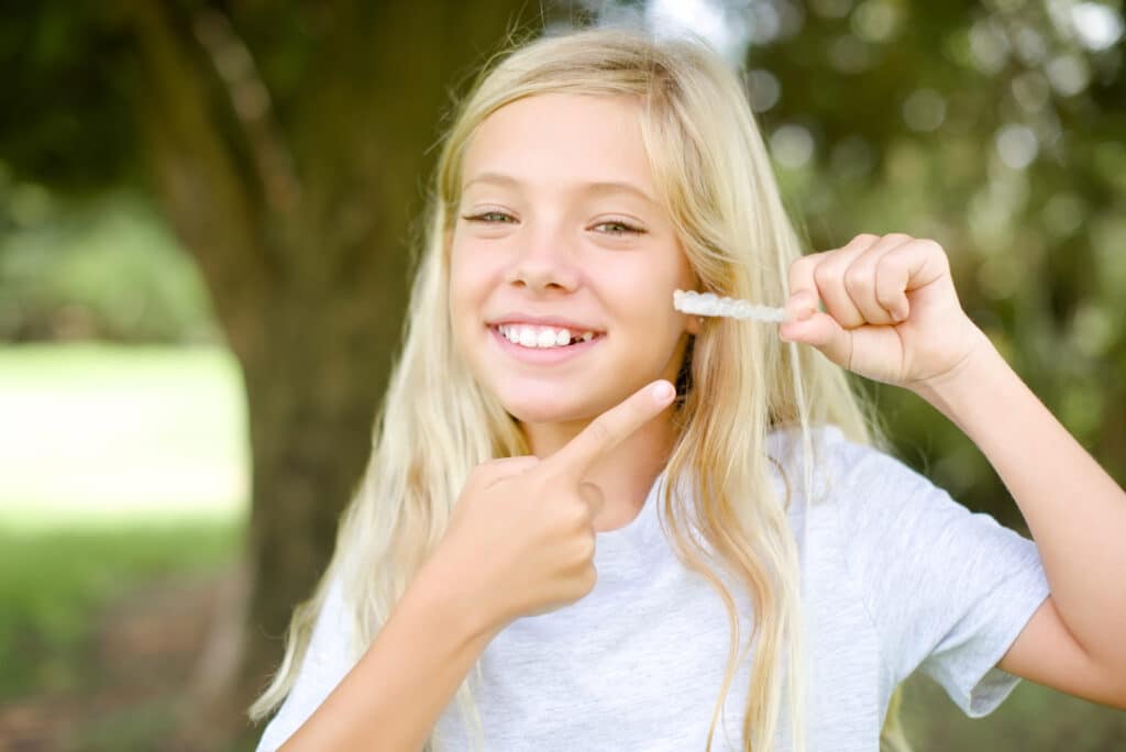 little kid girl wearing aligner